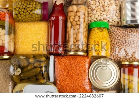 Emergency survival groceries on kitchen table closeup flat lay Royalty-Free Stock Photo #2224682607