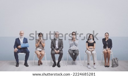 Patients with different diseases and injuries in the waiting room, healthcare and assistance concept, blank copy space Royalty-Free Stock Photo #2224685281