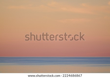 Sea and clear cloudless sunset sky. Natural color gradient, minimalist background