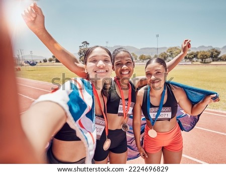 Selfie, medal and friends with a British flag after running, fitness and sports at a stadium. Collaboration, winning and women athlete group with a photo after achievement in sport or marathon