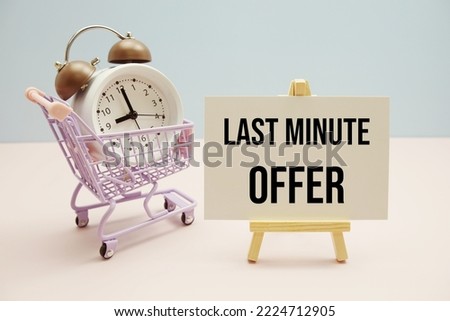 Last Minute Offer text message for promotion with alarm clock and shopping trolley cart on pink and blue background