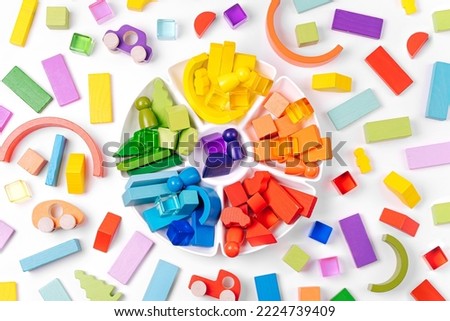 Educational games for Colors sorting. Red, yellow, green and blue wooden blocks in organizer. Colors sorter toy. Learning through play. Developing Montessori toddlers activities.