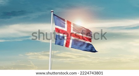 Iceland national flag waving in beautiful clouds.