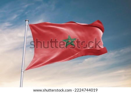 Waving Flag of Morocco in Blue Sky. Morocco Flag on pole for Independence day. The symbol of the state on wavy fabric. Royalty-Free Stock Photo #2224744019