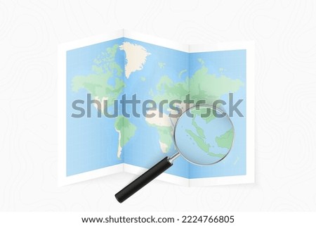 Enlarge Singapore with a magnifying glass on a folded map of the world. Vector paper map.