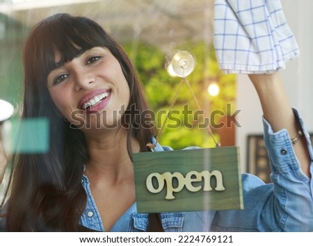 Smiling caucasian young woman barista cleaning shop glass and signage, ready to serve customers. Coffee shop and restaurant concept Start small business owner Lifestyle Leisure Food and drink Cafe