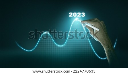 New Goals, Plans and Visions for Next Year 2023. Businessman draws increase arrow graph corporate future growth year 2022 to 2023. Planning,opportunity, challenge and business strategy. Royalty-Free Stock Photo #2224770633