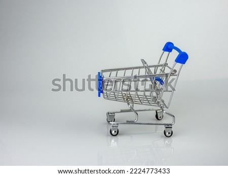 Shopping cart on white background with light and shadow. schopping concept.