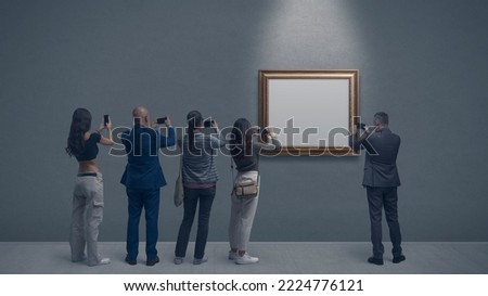People at the art gallery, they are taking pictures of a painting using their smartphones Royalty-Free Stock Photo #2224776121