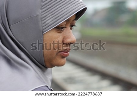 
Close up photo of Muslim woman wearing hijab purposely blurred background with space for text. Selective focus.
