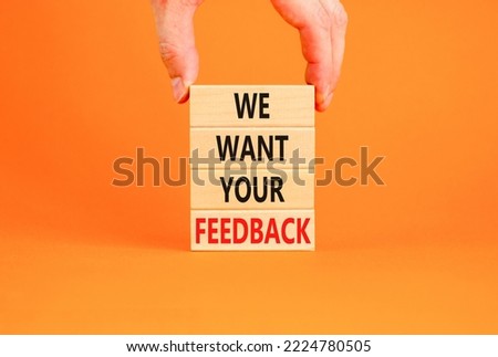 Support and we want your feedback symbol. Concept words We want your feedback on wooden blocks on beautiful orange background. Businessman hand. Business, support we want your feedback concept.