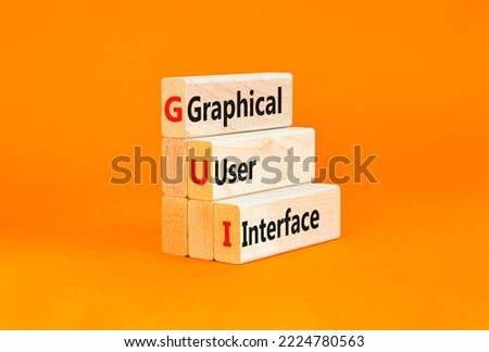GUI graphical user interface symbol. Concept words GUI graphical user interface on wooden blocks on a beautiful orange background. Business and GUI graphical user interface concept. Copy space.