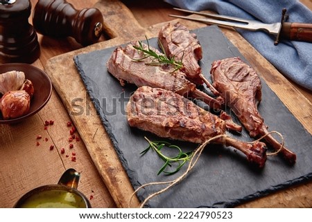Lamb steak on the wooden table, Frenched rack
