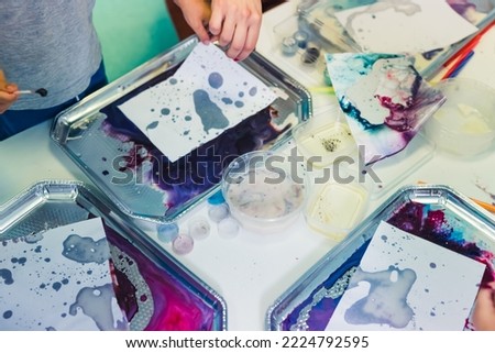 closeup view of the table full of water paints brushes and papers in the nursery. High quality photo