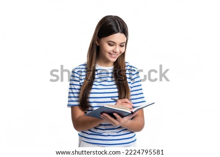 happy teen girl writing school diary isolated on white background. teen girl writing school diary Royalty-Free Stock Photo #2224795581