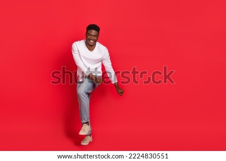 Full length photo of overjoyed laughing carefree male dancing flirting with girlfriend isolated on red color background