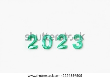 2023 Green Numbers on White Table. Modern New Year Background. Creative Greeting Card. Flat Lay, Top View, Copy Space. Banner Design. Minimal Festive Mock Up with Numbers. Time to Celebrate Holiday