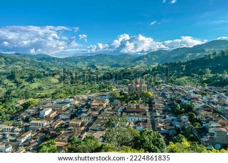 Wide panorama of the superb village (pueblo) of Jerico, Antioquia, Colombia, with a blue sky and the Andes Mountains in the background. Picture taken from el Morro el Salvador.