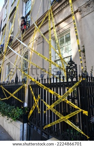 Halloween decorations on the building. Yellow police tape.