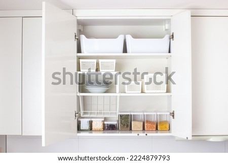 House decor ideas. Storage in the kitchen. Home organization. White shelf and modern interior. Royalty-Free Stock Photo #2224879793