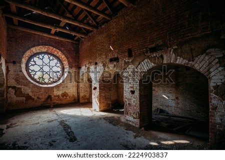 Round stained glass window in old abandoned castle. Royalty-Free Stock Photo #2224903837