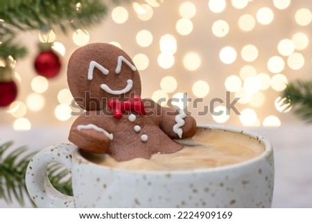 Gingerbread cookie man in a cup of hot chocolate or cappuccino