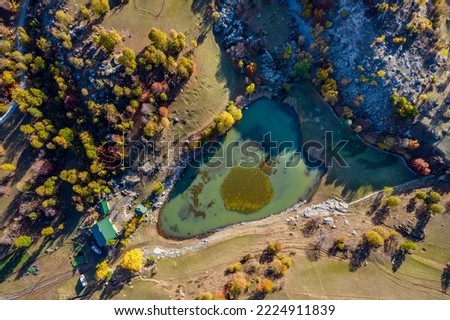Autumn view in Savsat. Artvin, Turkey. Beautiful autumn landscape with colorful trees. Bazgiret Maden Village and Lake. Aerial drone shot.