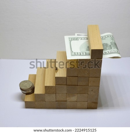 wooden growth steps with coins and paper dollars on a white background. the concept of development, career growth and profit