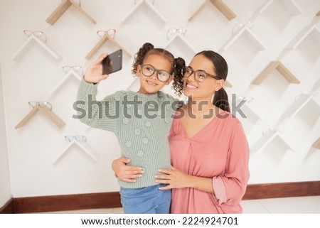 Selfie, phone and family with vision glasses at retail shop for wellness, eye care and health. Mother, child and smile for smartphone social media photograph together in expert optometry shop.