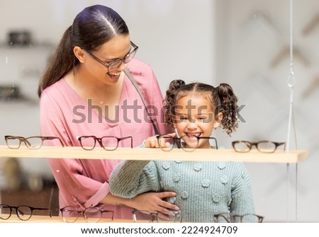 Decision, glasses and girl with her mother at the optometrist for vision and check on eyes together. Customer, medical and child shopping for eyeglasses with her mom at the ophthalmologist clinic Royalty-Free Stock Photo #2224924709