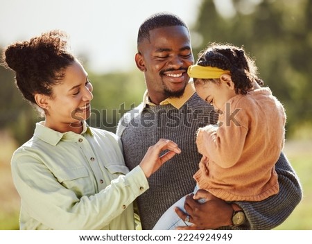 Love, family and happy girl with parents in a park, laughing and playing while bonding in nature. Love, happy family and child relax, play and enjoy quality time with mother and father in a forest