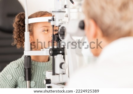 Child, kid or girl in optometry eye exam with optometrist, ophthalmologist or consulting medical profession and clinic slit lamp. Eye test, children eye care or vision check for healthcare insurance Royalty-Free Stock Photo #2224925389