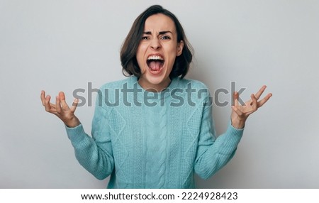 Close up shot of screaming crazy frustrated woman with anxiety, anger and depression. Very upset and emotional woman crying. Young girl with angry and furious face. Human expressions and emotions Royalty-Free Stock Photo #2224928423