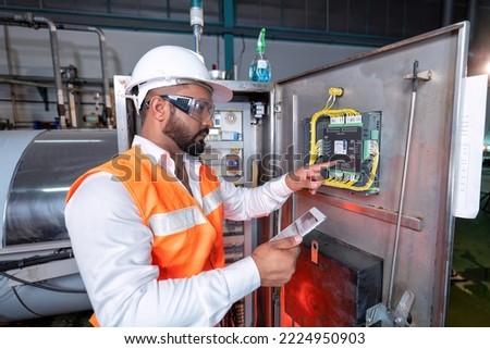 Electrical engineer inspection control panel and commissioning during pressure steam drum shutdown Royalty-Free Stock Photo #2224950903