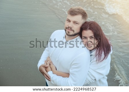 Loving couple on the sea. Tender relationship between a man and a woman. Ordinary people show love to each other. Happy couple hugging and kissing. Family concept. Concept for valentine's day. Royalty-Free Stock Photo #2224968527