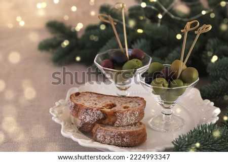  Assortment of fresh olives  in small glasses with slice of baguette