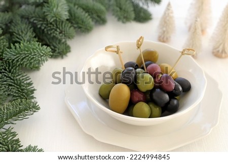 Assortment of fresh olives  in a white bowl