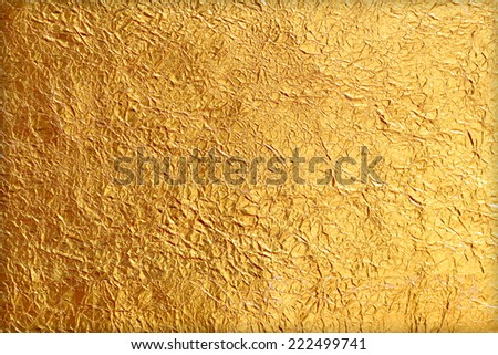 Shiny yellow leaf gold foil texture background Royalty-Free Stock Photo #222499741