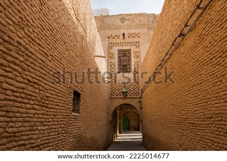 Beautiful facades of a historic building on a narrow street in the medina of Tozeur, Tunisia. Royalty-Free Stock Photo #2225014677