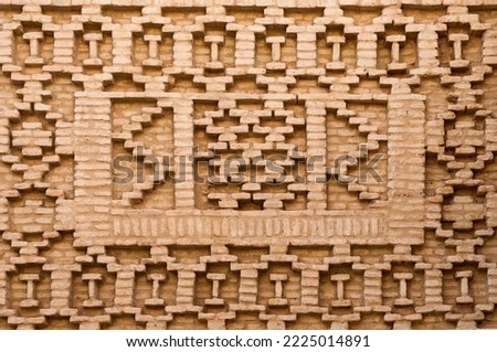 Geometric brickwork on the wall of a historic building in a narrow street in the Medina, Tozeur, Tunisia. Royalty-Free Stock Photo #2225014891