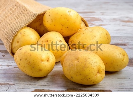 a pile of potatoes in a paper bag Royalty-Free Stock Photo #2225034309