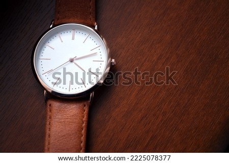 Leather watch with mechanism on orange background