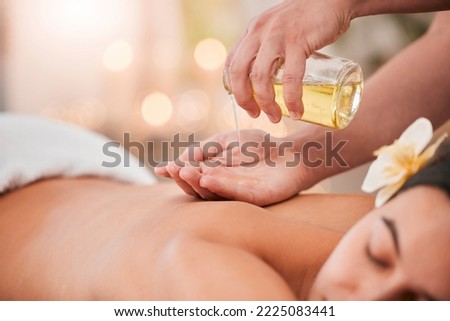Hand, oil and massage on woman at a spa for wellness, relax and stress relief with back massage and masseuse. Luxury, back and girl hands of therapist with product for body, skin and muscle therapy Royalty-Free Stock Photo #2225083441