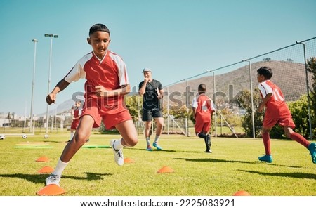 Soccer, children and training or practice for sports competition or game on soccer field for fitness, exercise and energy. Football player, cone and sport with kids coach outdoor for team practice Royalty-Free Stock Photo #2225083921