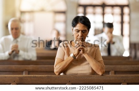 Faith, woman and praying in church, religion and spiritual connect, communication or believe. Senior female, mature lady or prayer in chapel with congregation, worship or trust with gratitude or hope Royalty-Free Stock Photo #2225085471