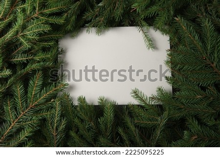 Holidays greeting card or banner composition with pine tree branches. Merry Christmas background and Happy New Year 2023.
