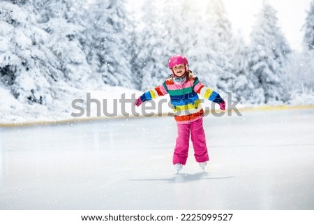 Child skating on natural ice on snowy winter day. Kids with skates. Little girl skating on frozen lake in snowy park. Snow and winter fun. Healthy outdoor activity for children. Kid on ice rink.