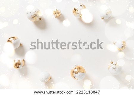 Beautiful Christmas frame with white and golden decorative balls and garland on white background. Xmas greeting card with copy space. Happy New Year.