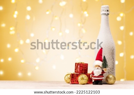 Christmas and New Year holidays background. Santa Claus with gifts, golden deer and bottle champagne on festive banner.
