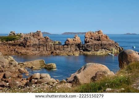 Pink granite coast in Brittany, view between the magnificent rocks on the blue sea